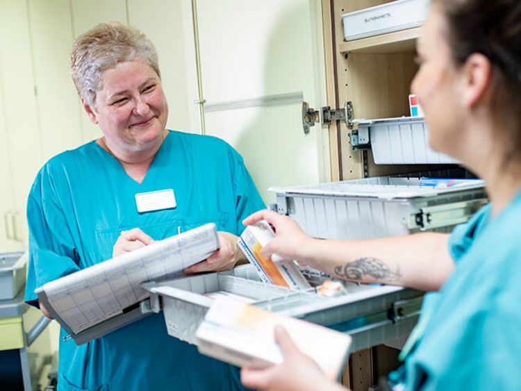 Weibliche Pflegekräfte stellen Medikamente für die Patienten zusammen